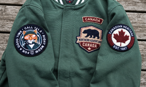 Wholesale custom chenille patches displayed on a green jacket with Canadian themed designs